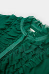 Close-up of a green ruffled garment on a white background