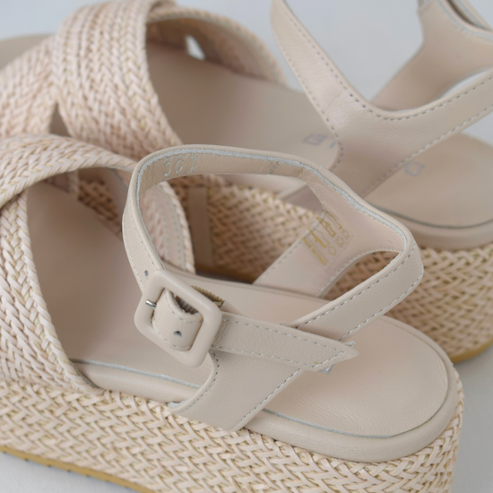 Blush coloured flatforms in a raffia