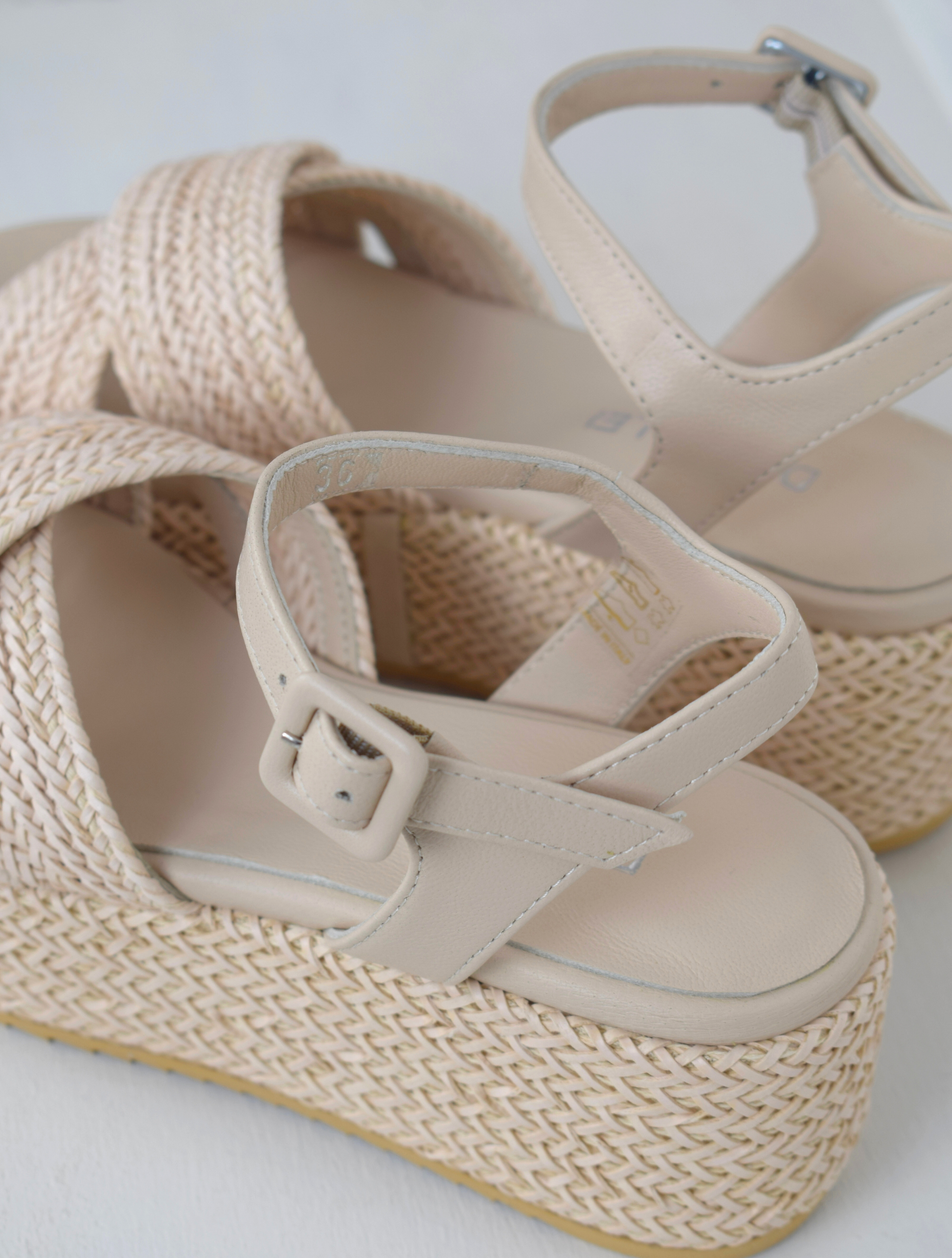 Blush coloured flatforms in a raffia