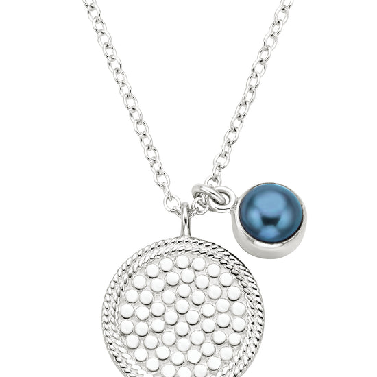silver pendant necklace with dot detailing and a blue pearl small charm on a silver chain from anna beck 