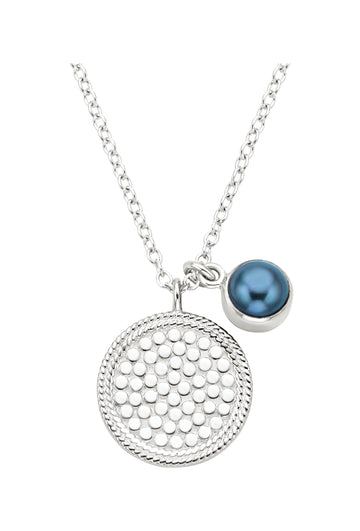 silver pendant necklace with dot detailing and a blue pearl small charm on a silver chain from anna beck 