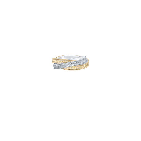 A two-tone wrap ring featuring a gold band with pavé-set clear stones and a silver band with a milgrain texture, shown on a plain white background.