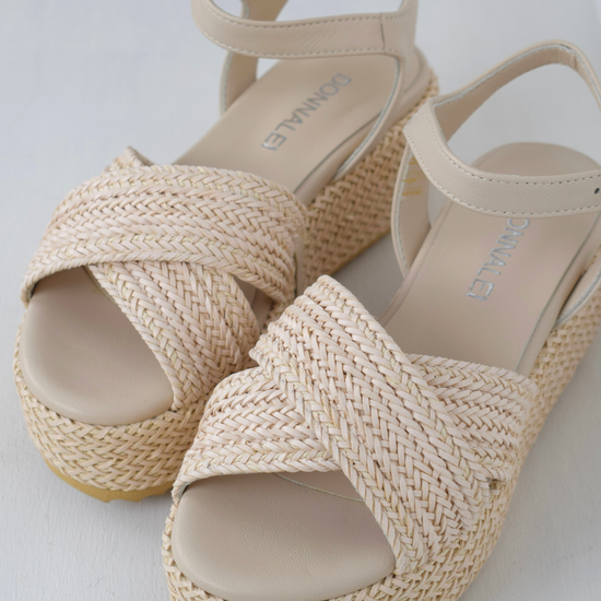 Blush coloured flatforms in a raffia