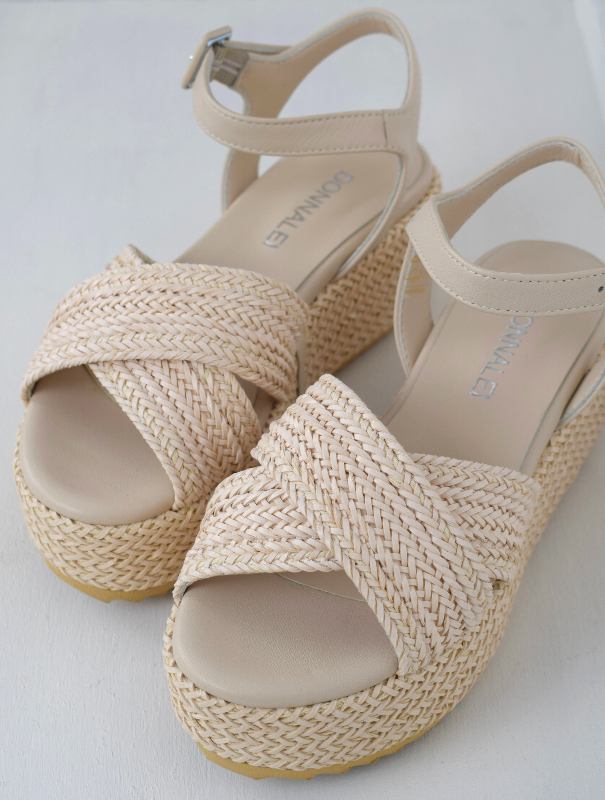 Blush coloured flatforms in a raffia