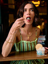 Lady eating ice cream and wearing rachel jackson jewellery close up 
