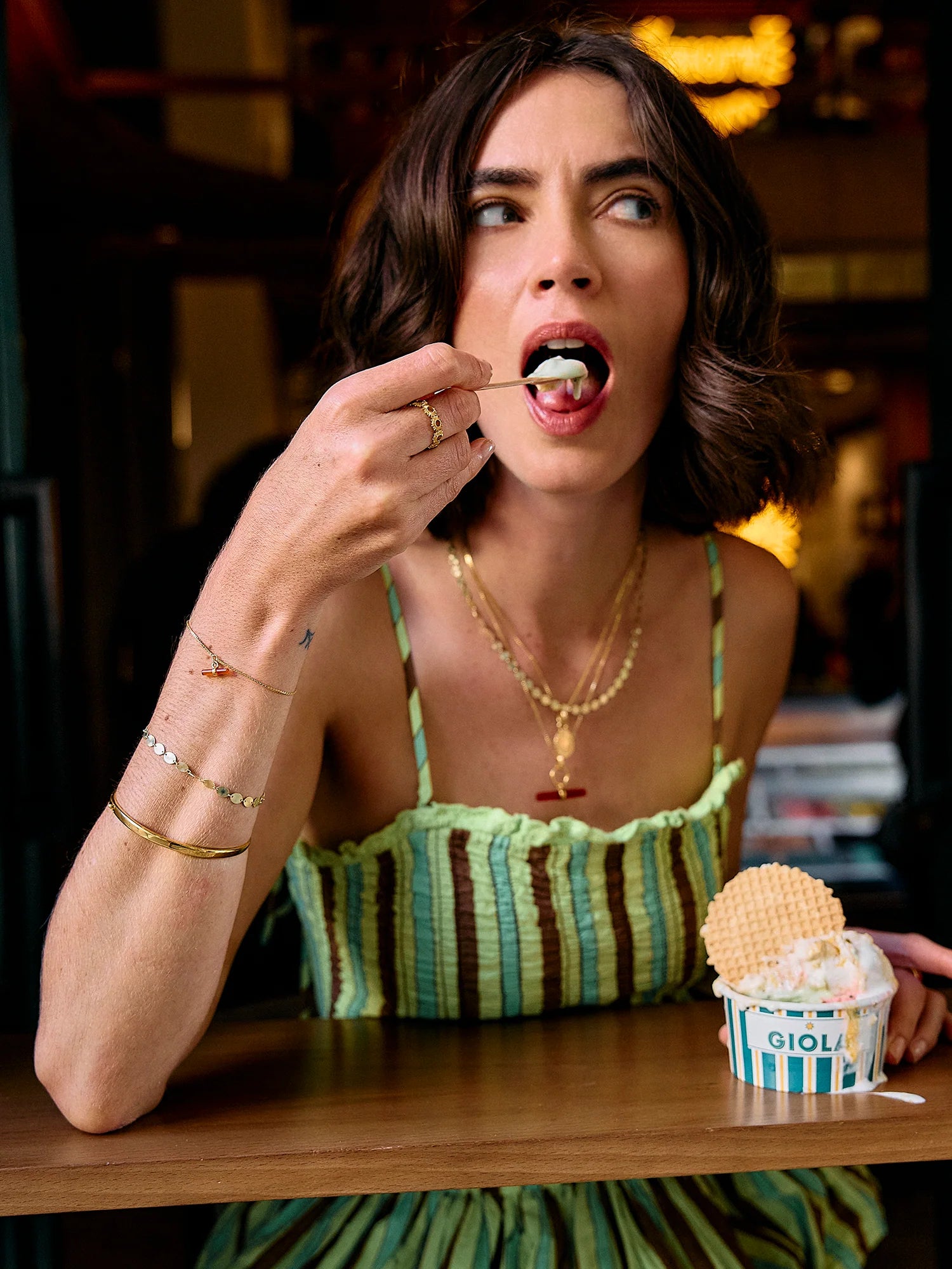Lady eating ice cream and wearing rachel jackson jewellery close up 