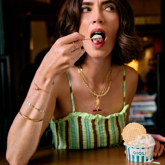 Lady wearing Rachel Jackson Jewellery eating ice cream close up 