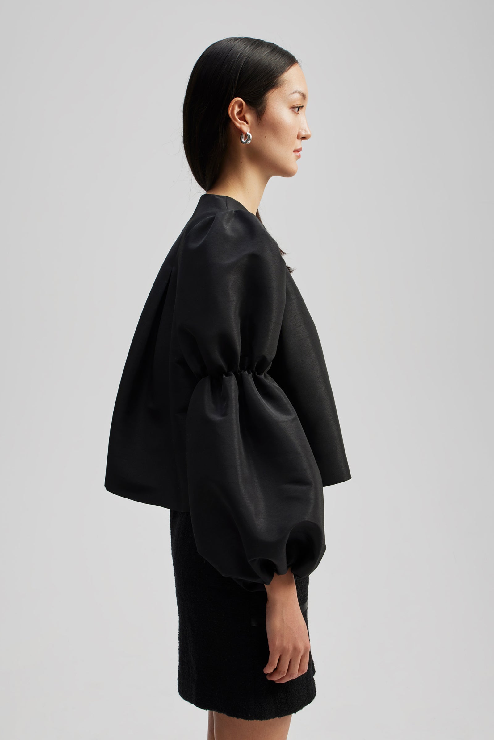 Black collarless shirt with puff sleeves and elasticated details