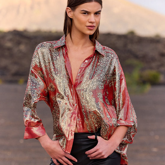 Woman wearing a patterned shirt in a desert setting