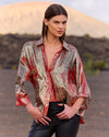 Woman wearing a patterned shirt in a desert setting