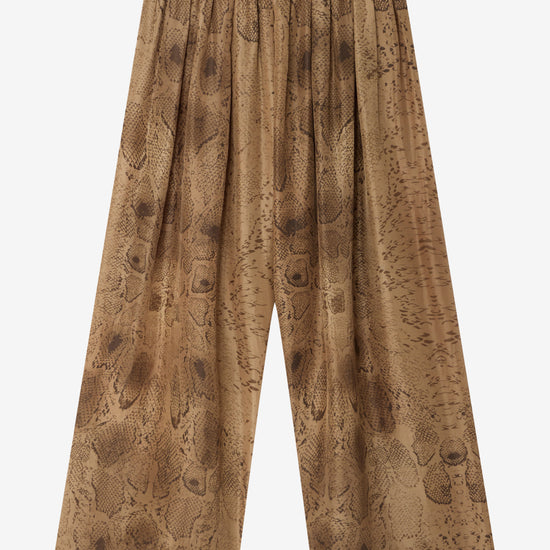 snake print wide leg trousers on a white background 