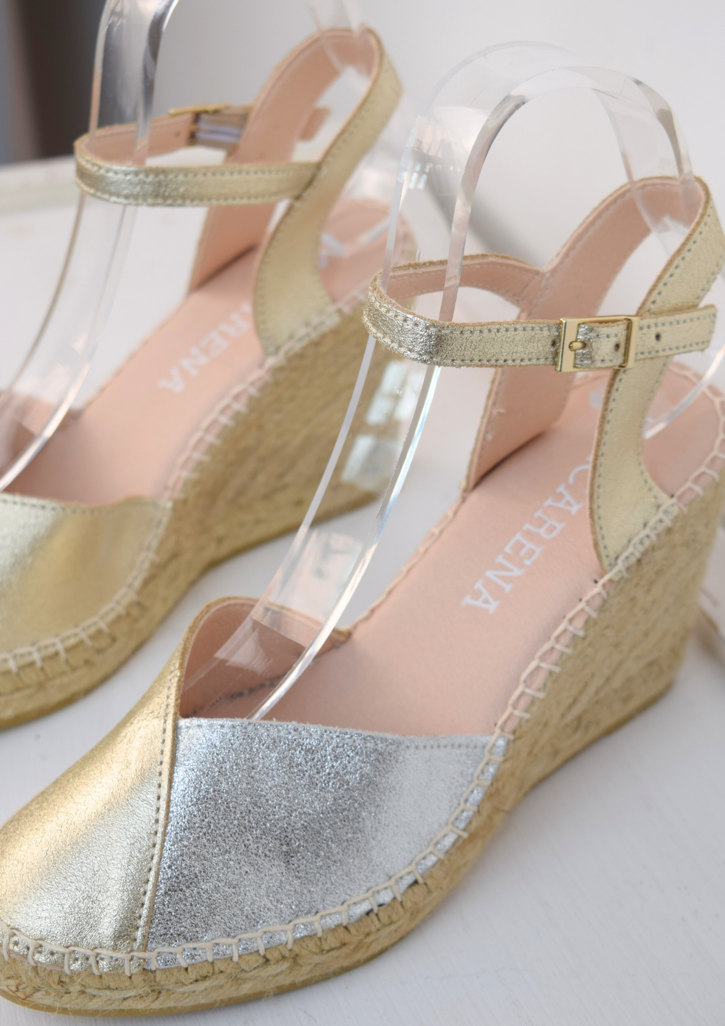 A raffia wedge sandal with a 2 tone top. Made up of silver and gold.