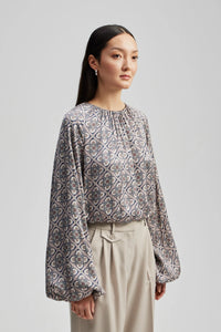Crew neck top with long balloon sleeves and elasticated cuffs hem and neckline in a grey blue and teal tile pattern