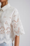 White cropped shirt with classic collar short sleeves and embroidery and broderie anglais throughout