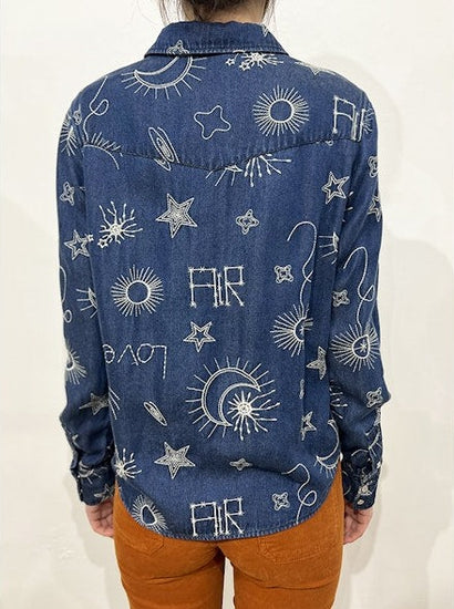 Rear view of blue shirt detailing embroidered pattern 