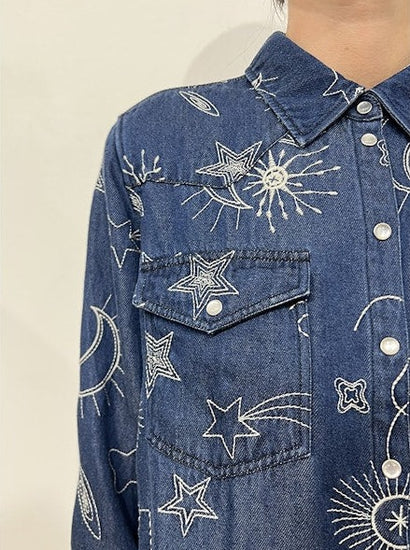 Close up view detailing embroidered pattern,  front pocket and collar