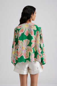 Green button through blouse with bold floral design and pink tuck features with long puff sleeves