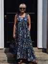 Maxi navy dress with all over floral print ruffle straps square neckline and tie back with elasticated backline and deep ruffle hem