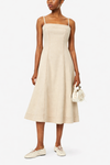 Woman wearing a ecru dress with white sneakers on a white background from Paige