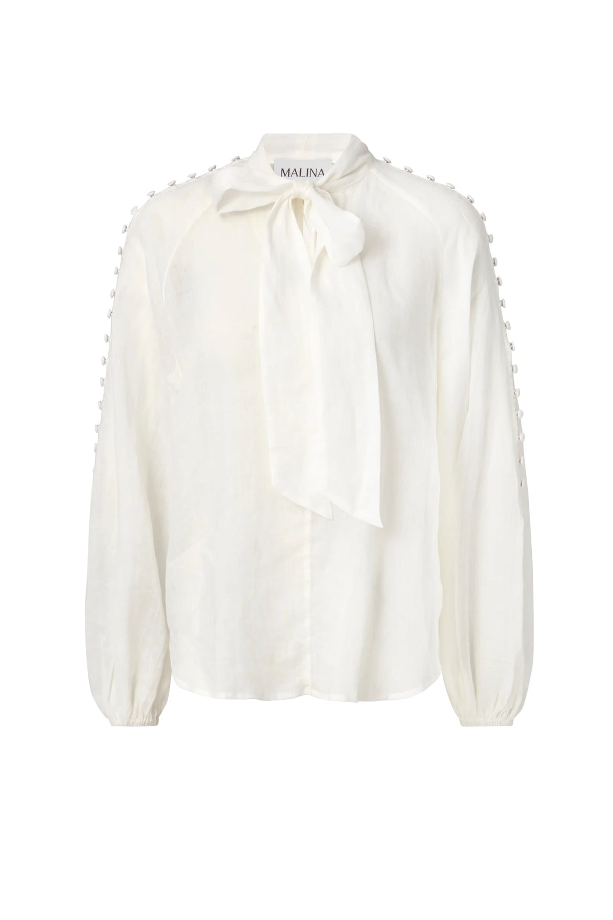 white long sleeved shirt with bow neck and covered buttons down the raglan sleeves