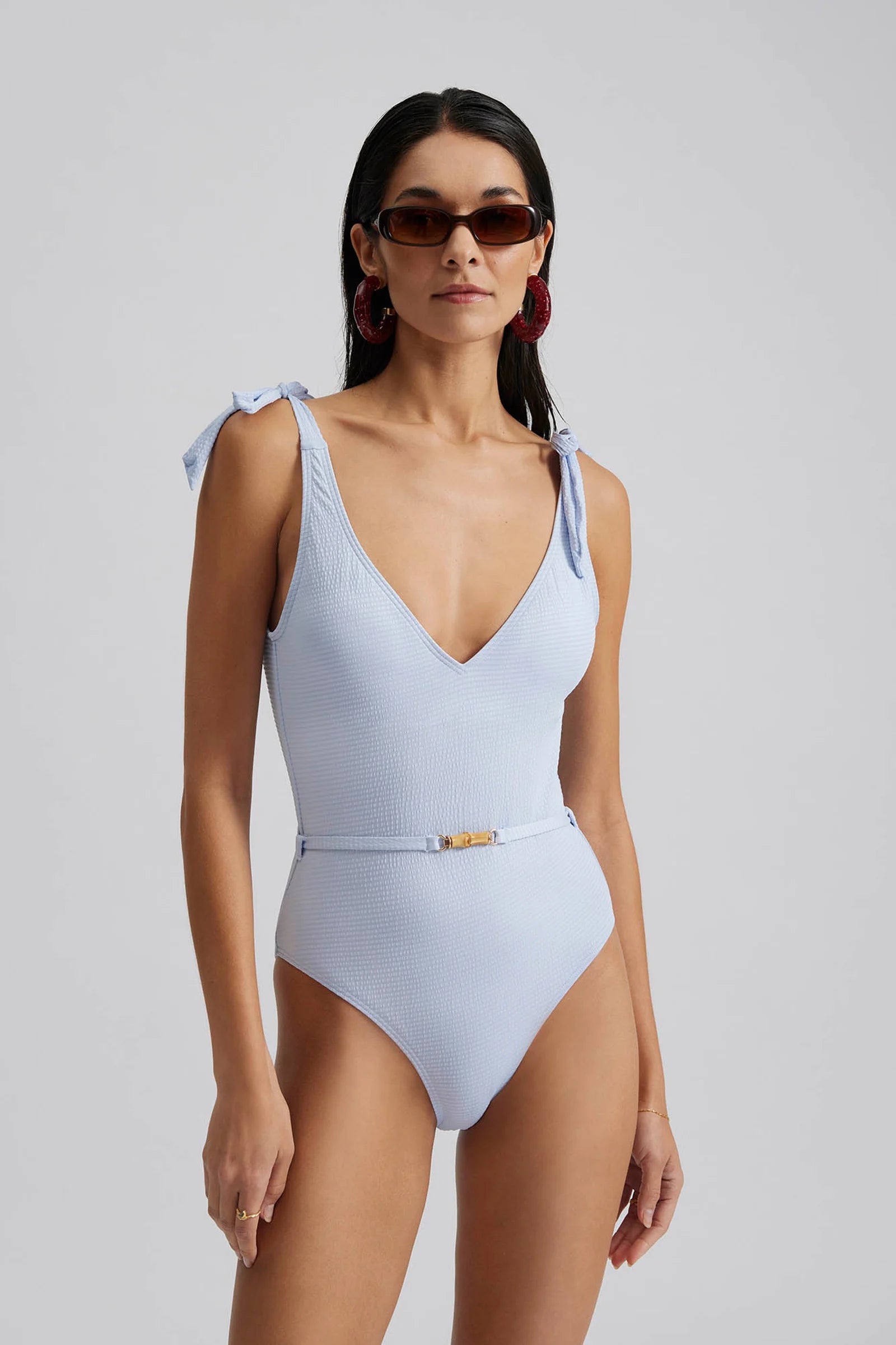 Baby blue V neck and back swimsuit in textured fabric with tie straps and belt