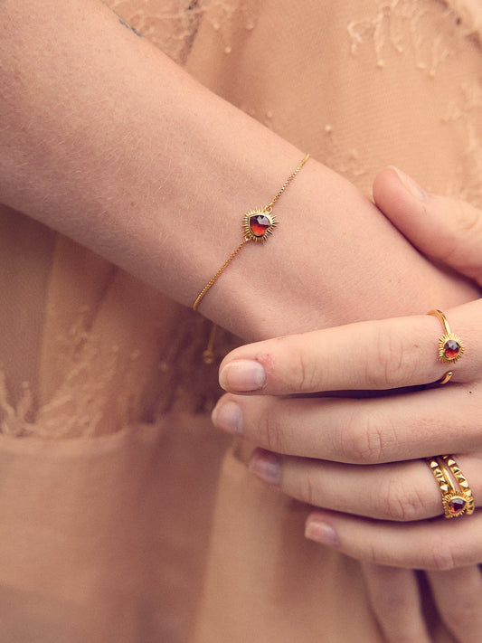 gold bracelet with spiky heart with red stone inside and lobster clasp from rachel jackson model shot