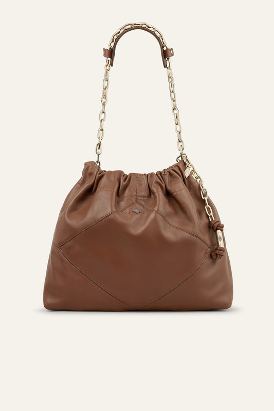 Brown leather handbag with chain handle on a beige background from bash
