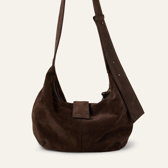 Brown suede handbag on a light beige background