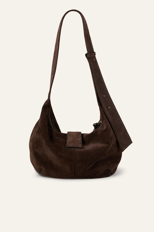 Brown suede handbag on a light beige background