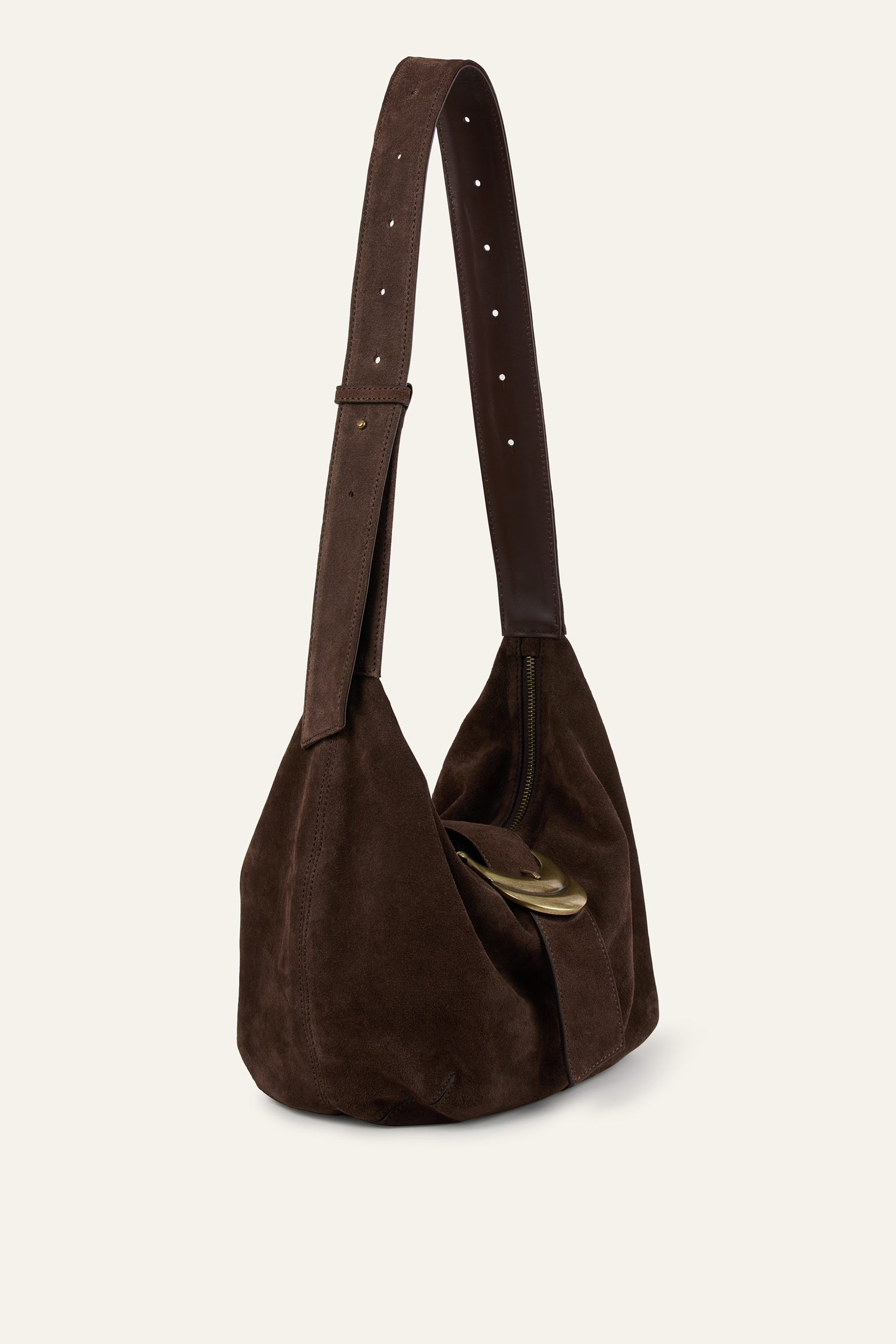 Brown suede handbag with a strap on a beige background
