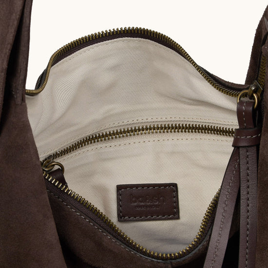 Brown leather bag with a visible brand label on a white background
