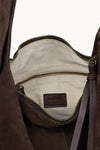 Brown leather bag with a visible brand label on a white background