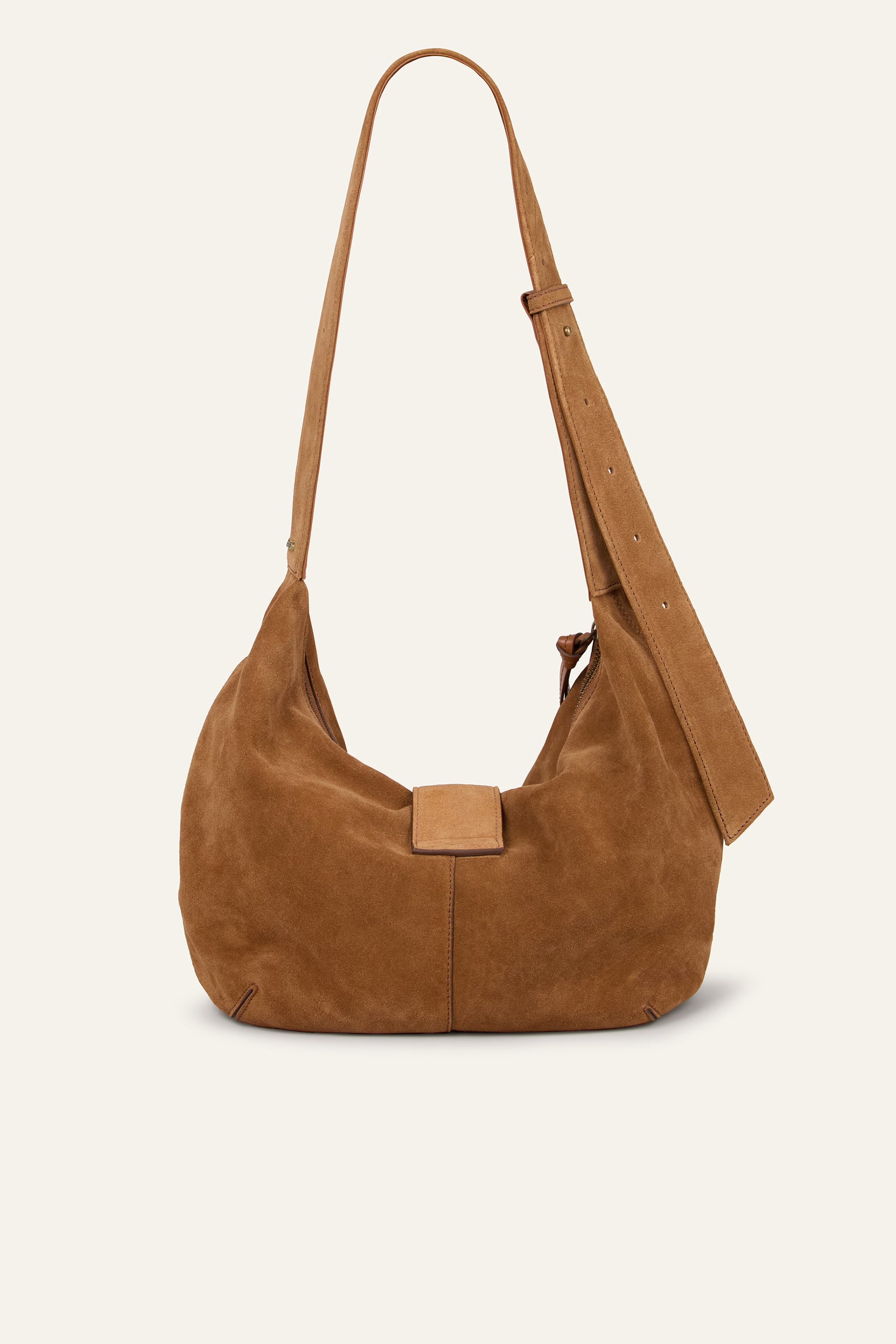 Brown suede handbag with a strap on a beige background from Ba&sh