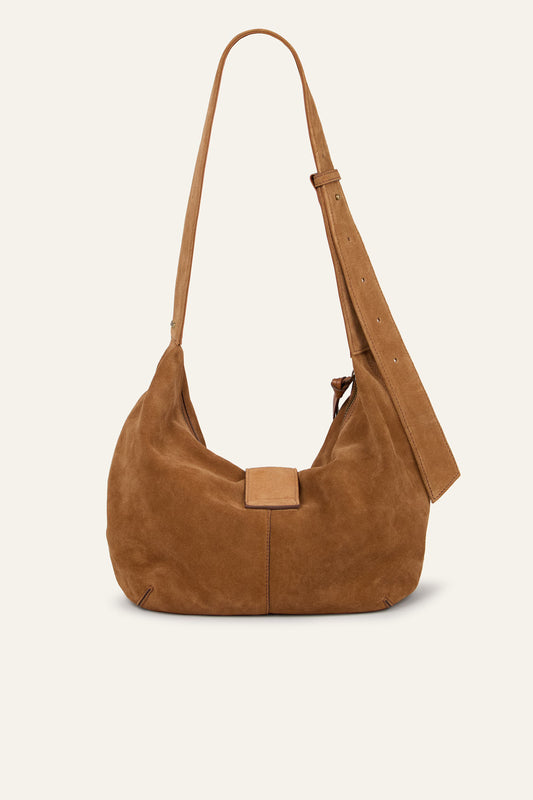 Brown suede handbag with a strap on a beige background from Ba&sh