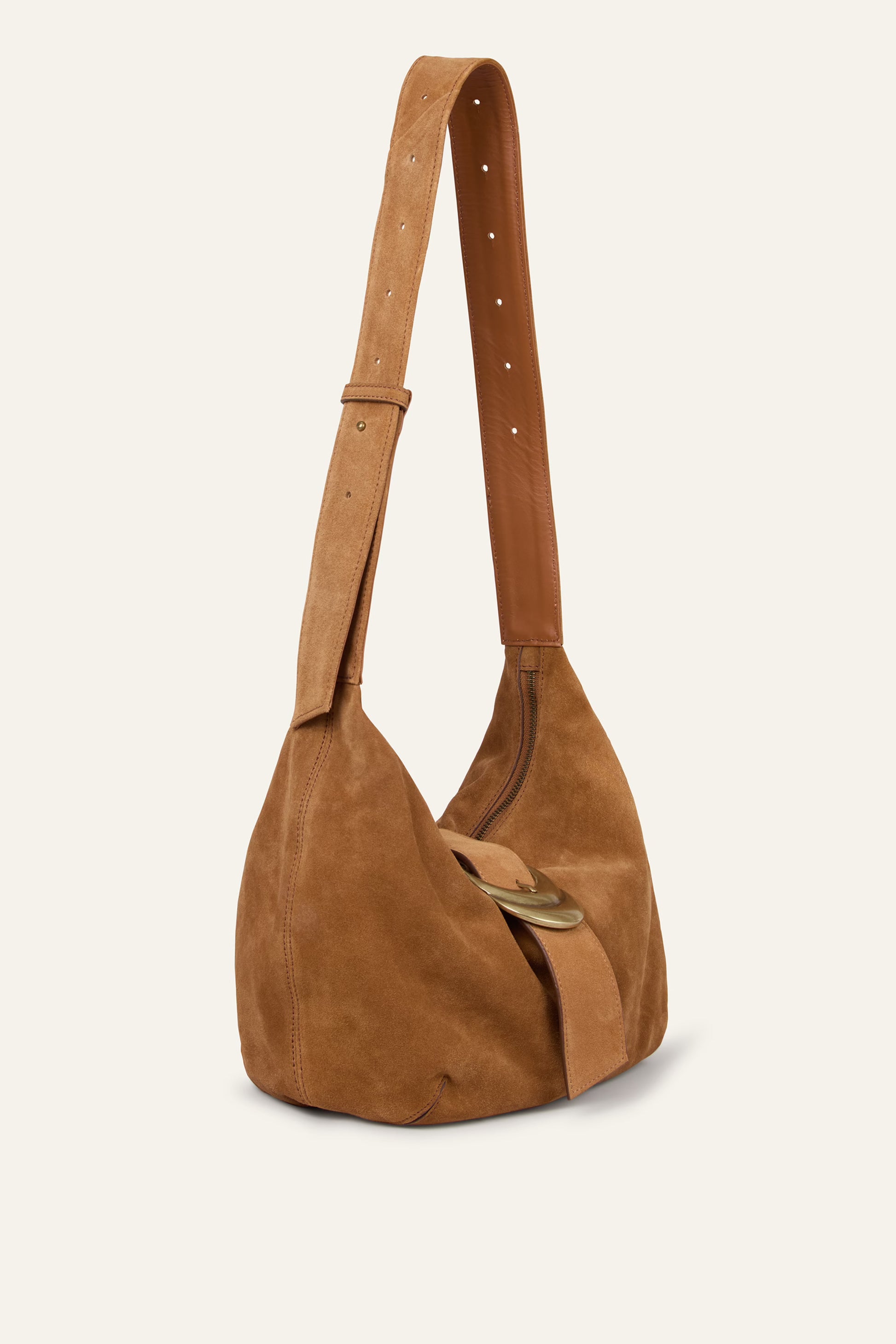 Brown suede handbag with a strap on a beige background