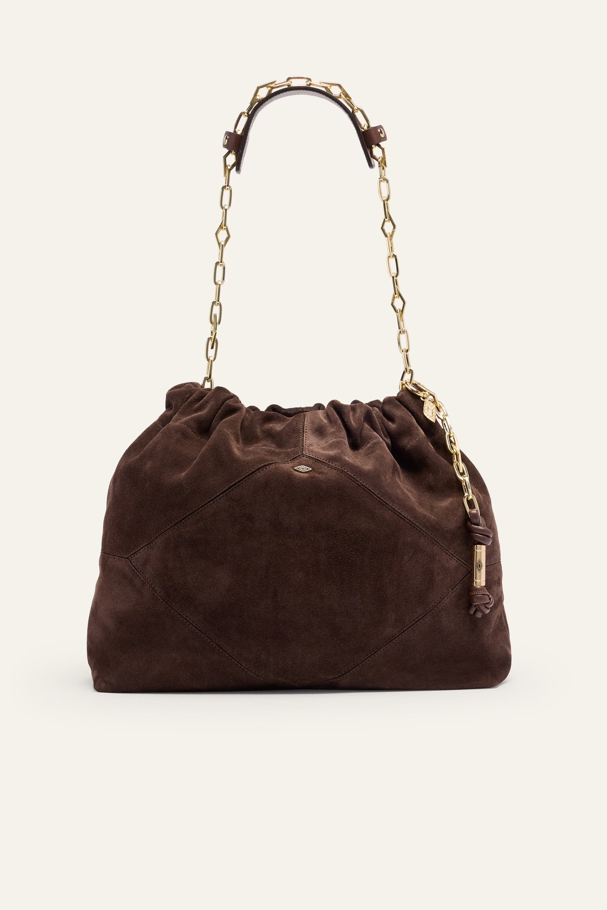 Brown suede handbag with gold chain handle on a white background