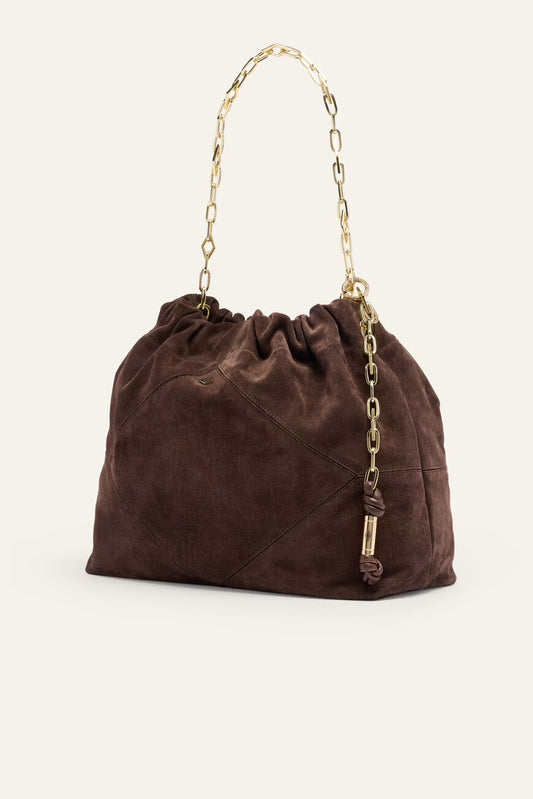 Brown suede handbag with gold chain handle on a white background