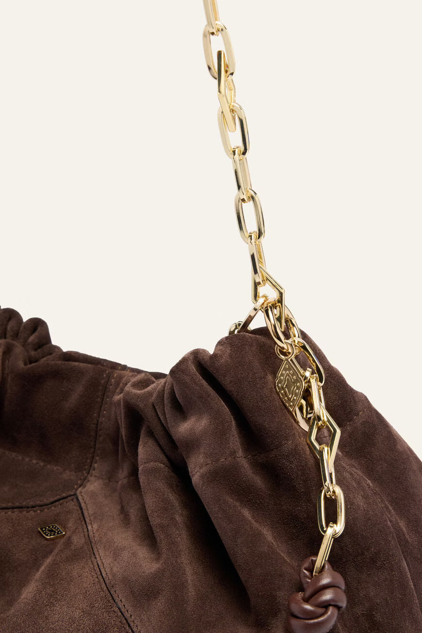 Brown bag with a gold chain detail on a beige background