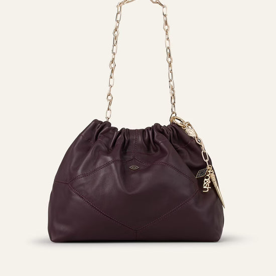 small burgundy leather scrunched bucket with gold chain strap and bag charm from ba&sh