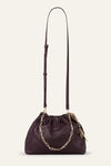 small burgundy leather scrunched bucket with gold chain strap and bag charm from ba&sh with longer cross body strap attached