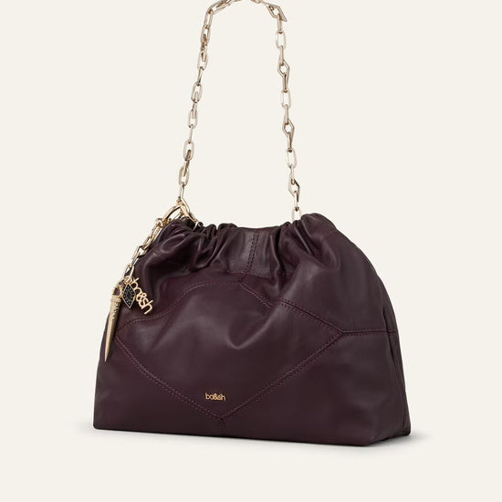 small burgundy leather scrunched bucket with gold chain strap and bag charm from ba&sh side view