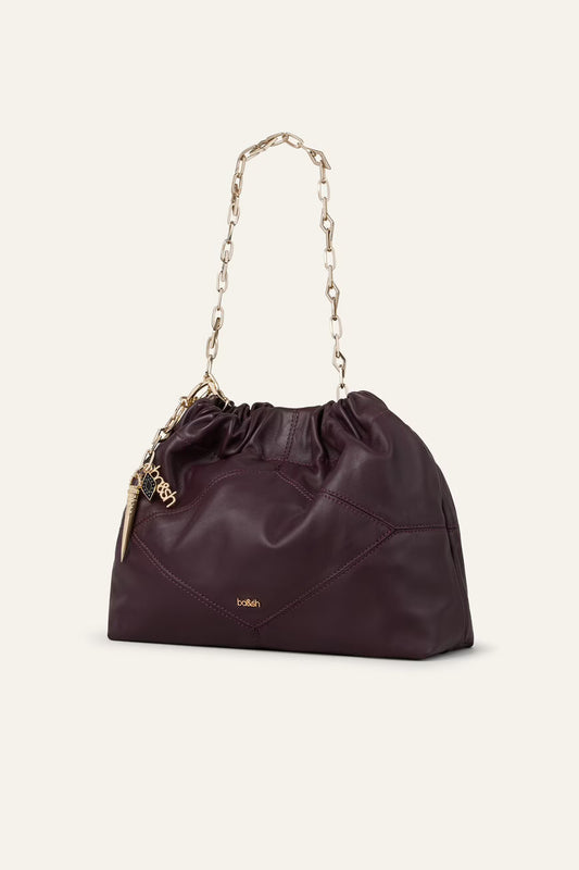 small burgundy leather scrunched bucket with gold chain strap and bag charm from ba&sh side view