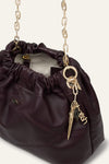 small burgundy leather scrunched bucket with gold chain strap and bag charm from ba&sh interior shot