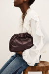 small burgundy leather scrunched bucket with gold chain strap and bag charm from ba&sh model shot