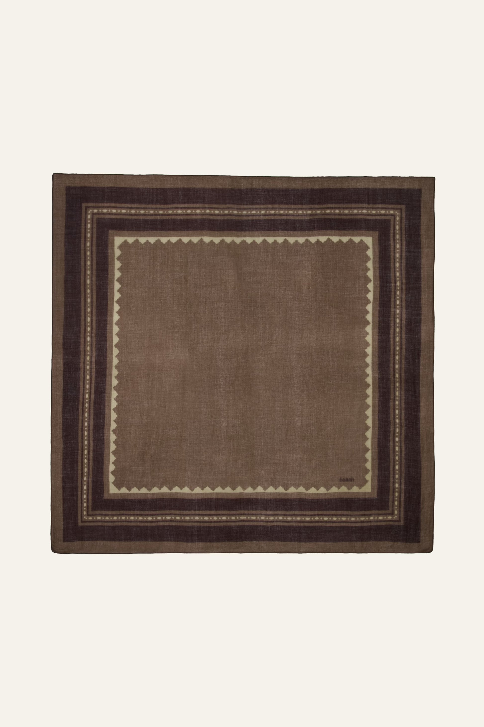 A square brown woven textile with a geometric border pattern, displayed flat against a light cream background.