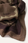 A close-up of a draped scarf in a brown, beige, and dark plum camouflage pattern, featuring the embroidered brand name 'balenciaga' on the left side.