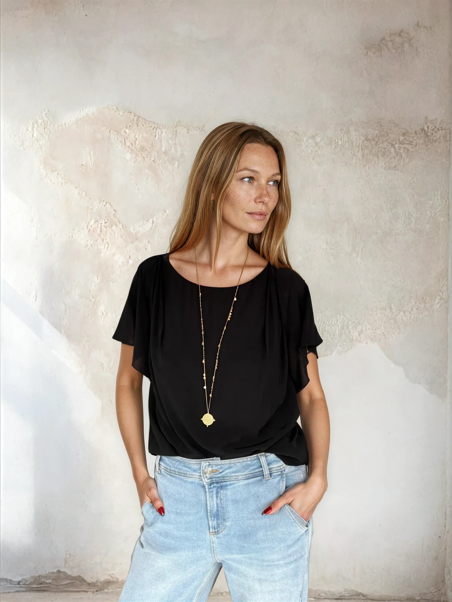 Black flutter sleeve top worn with blue denim