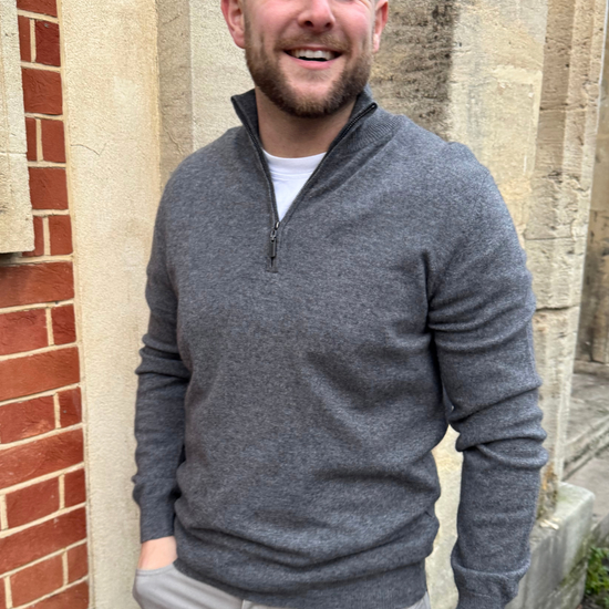 Male model wearing grey cashmere quarter zip jumper.