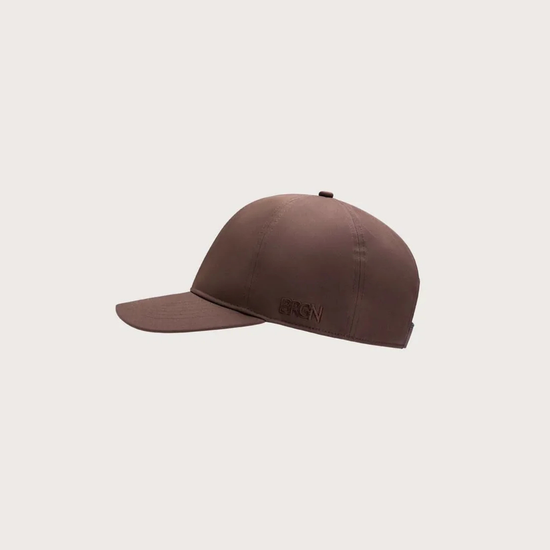 A dark brown structured baseball cap with a curved brim, shown from a side profile against a light gray background.
