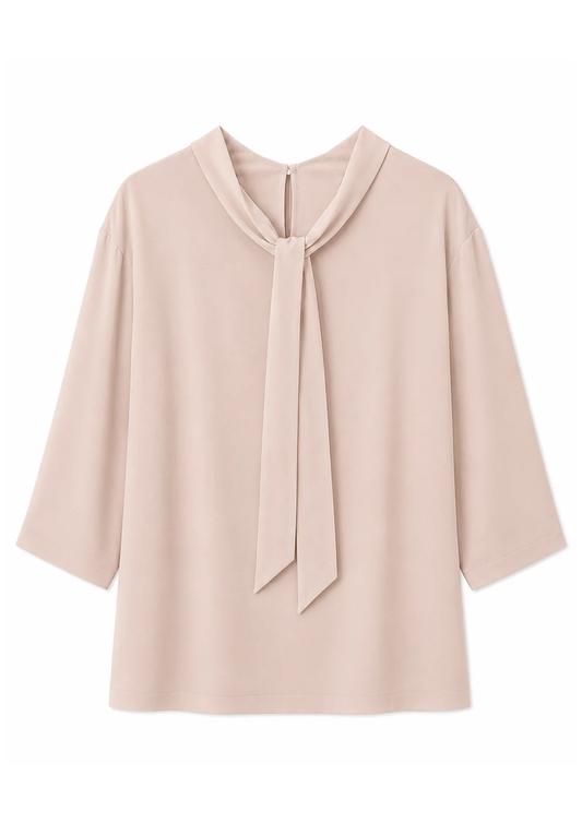 reverse flat lay of a blush pink blouse with a tie neck detail